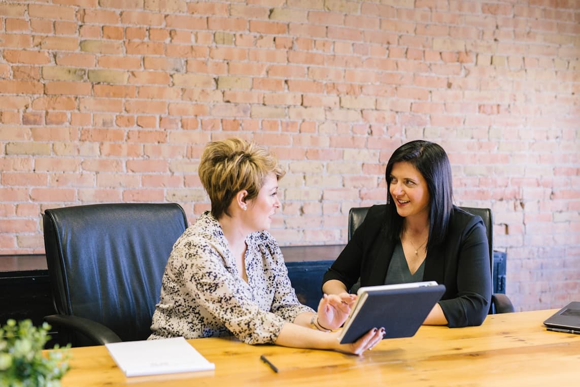 Two professionals reviewing career progress together